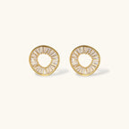 Gold-plated necklace and earring set with circular CZ crystal pendants featuring radial design on cream background