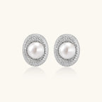 Elegant stud earrings with cream freshwater pearls surrounded by sparkly pavé crystals on rhodium-plated silver setting