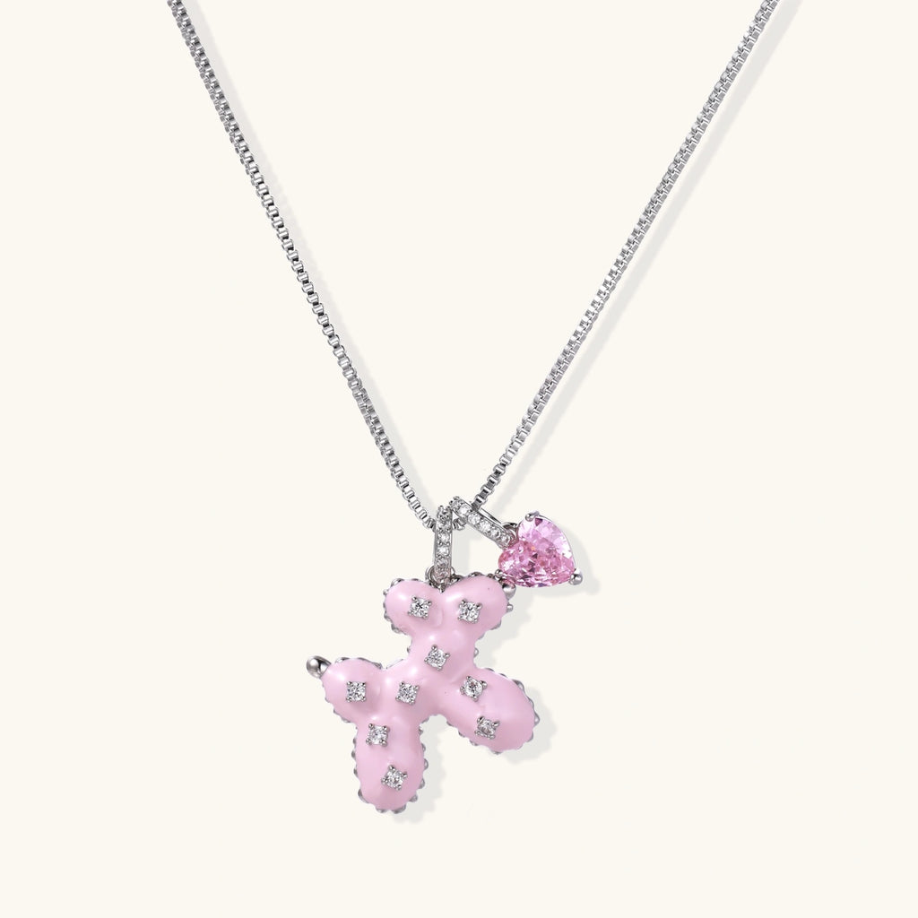 Pink enamel puppy pendant with crystal accents and heart charm on white gold chain