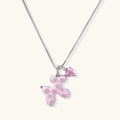 Pink enamel puppy pendant with crystal accents and heart charm on white gold chain