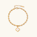 18K gold-plated oval bead bracelet with a four-leaf clover charm in mother-of-pearl or black enamel, adjustable lobster clasp, on white background.