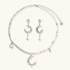Mixed-metal jewelry set featuring layered necklaces with crescent moon pendant and pearl beads, plus matching star-drop earrings.