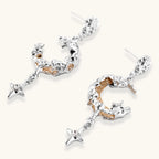 Mixed-metal jewelry set featuring layered necklaces with crescent moon pendant and pearl beads, plus matching star-drop earrings.