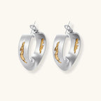 Artistic jewelry set featuring curved silver pendant with gold veining on black cord plus matching asymmetrical hoop earrings