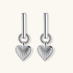 Platinum-plated 925 sterling silver rectangular hoop earrings with twisted ring connector and ribbed heart charm pendant.