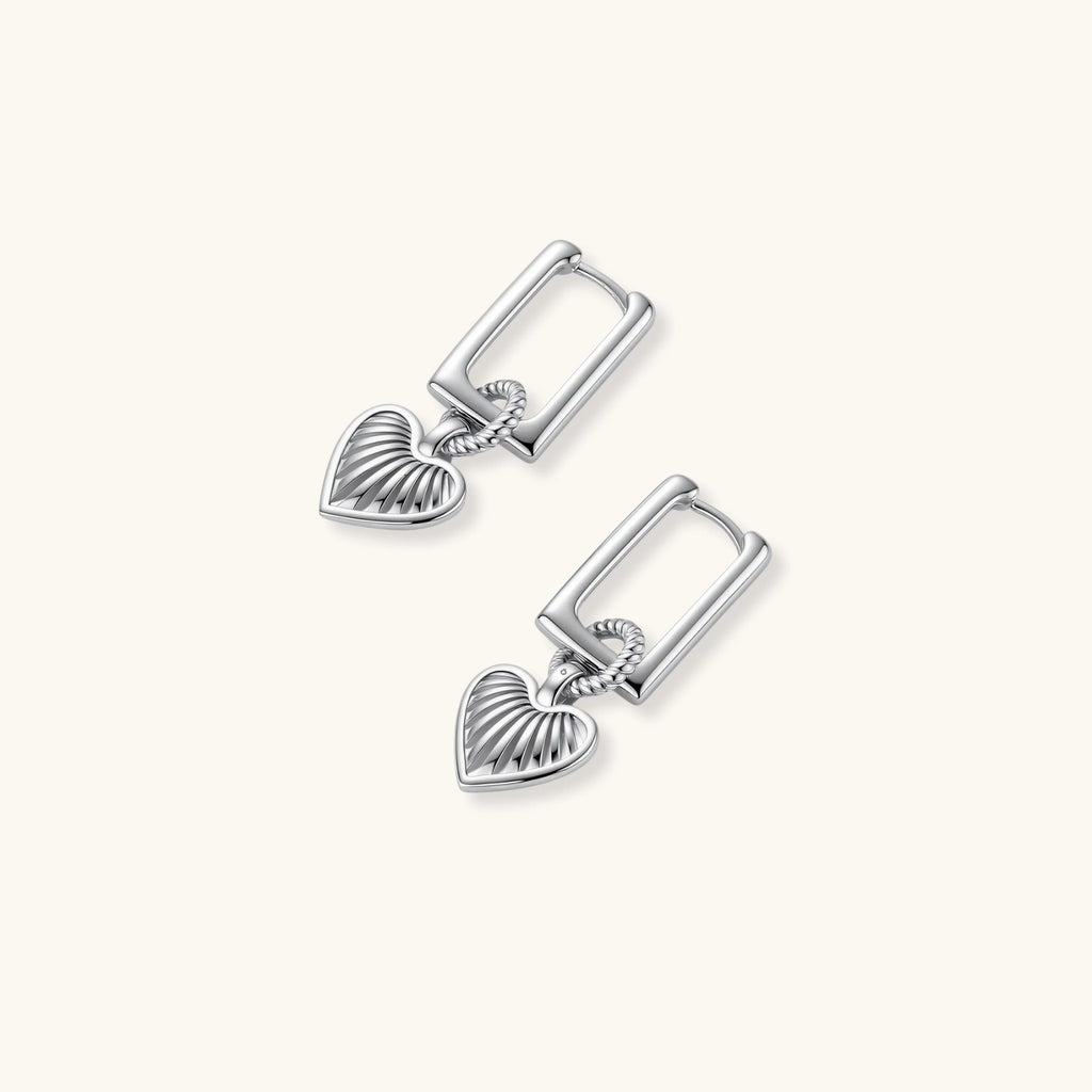 Platinum-plated 925 sterling silver rectangular hoop earrings with twisted ring connector and ribbed heart charm pendant.