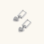 Platinum-plated 925 sterling silver rectangular hoop earrings with twisted ring connector and ribbed heart charm pendant.