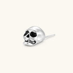 Matte silver skull stud earring with black enamel eye sockets and detailed teeth, post backing, 316L stainless steel.