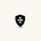 Silver stainless steel shield-shaped stud earring with black enamel and raised Maltese cross, rubber-secured backing.